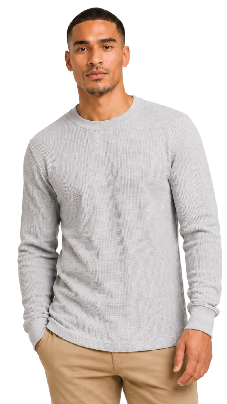 Man wearing a gray sweater and beige pants on a white background