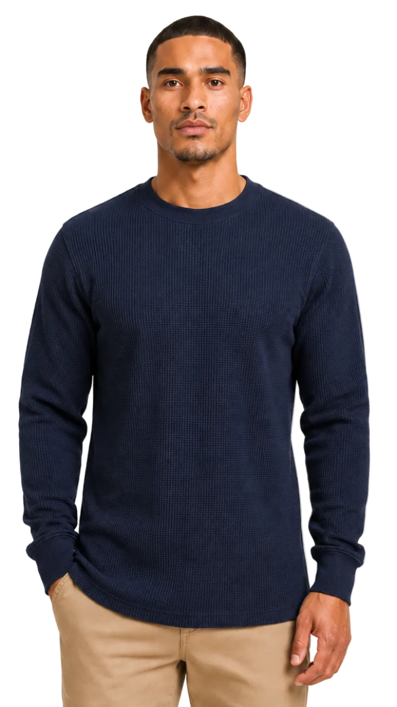 Man wearing a navy blue sweater against a plain background