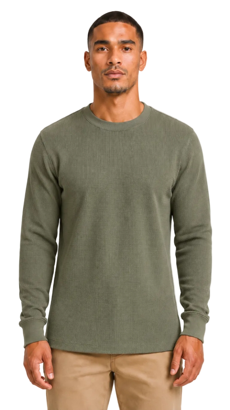 Man wearing a Olive sweater and beige pants against a white background