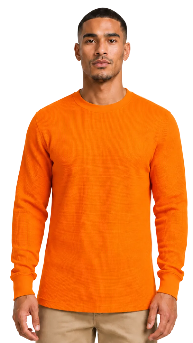 Man wearing an orange sweater on a plain background