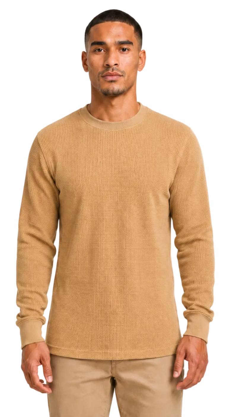 Man wearing a beige ribbed sweater against a white background