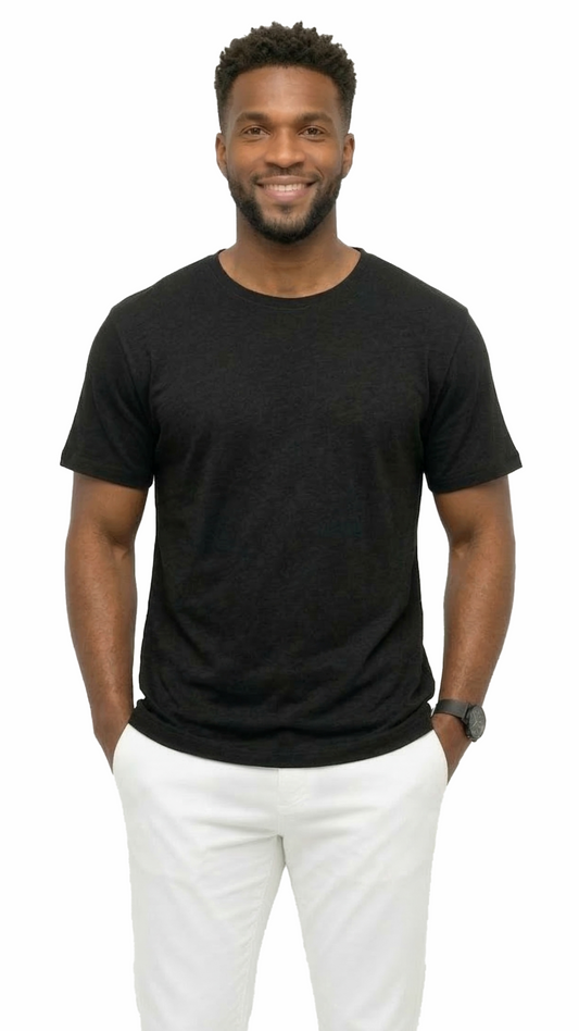 Man wearing a black t-shirt and white pants on a white background